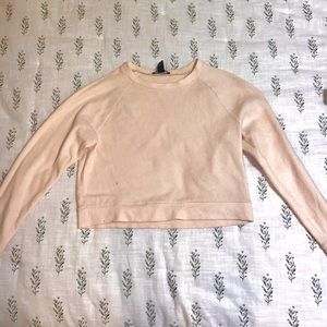 Cropped peach sweater with cuffed sleeves. Size small.